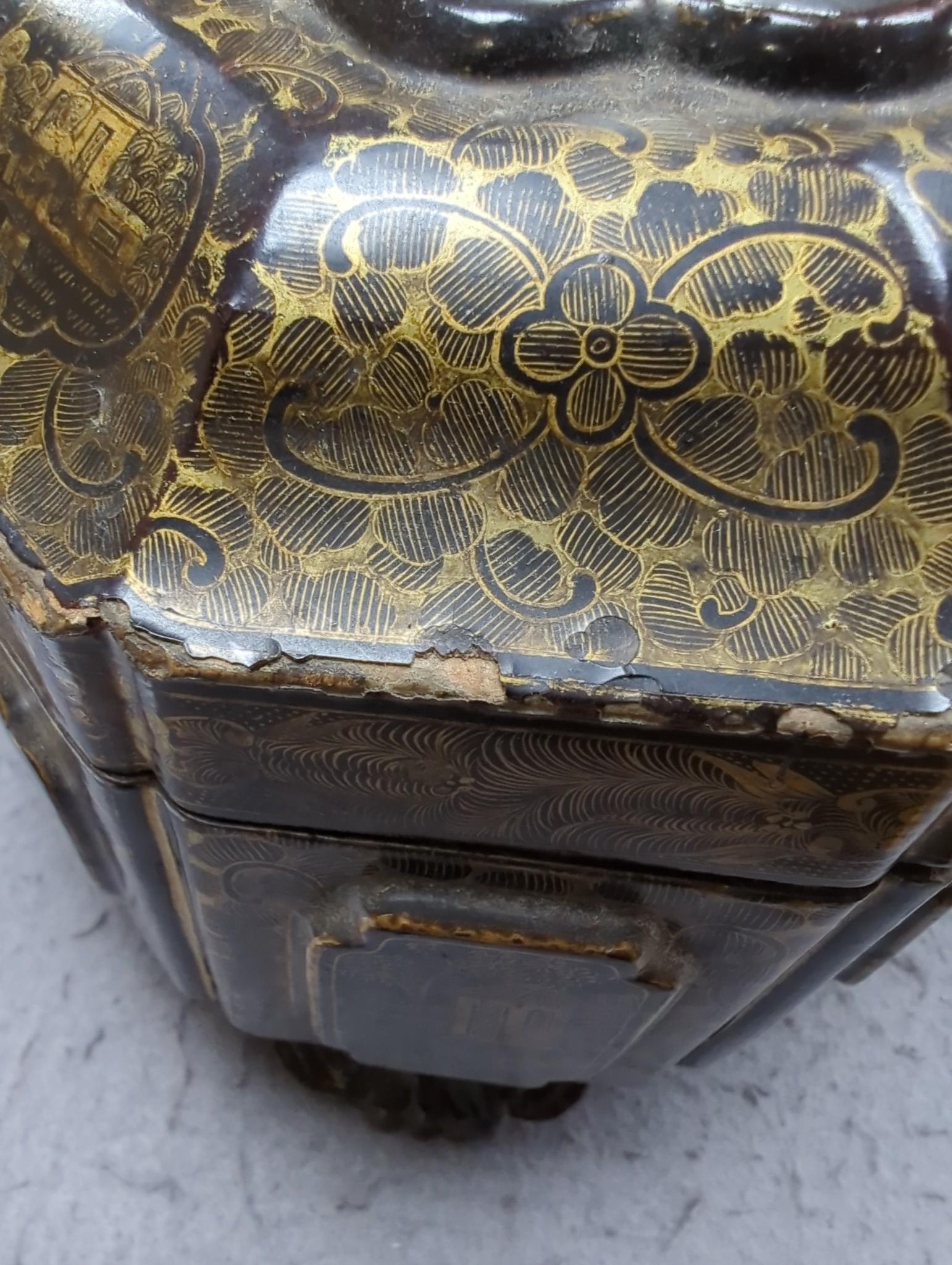 A 19th century Chinese chinoiserie lacquered sarcophagus form tea caddy, pewter lined interior with bone handles, 23cm